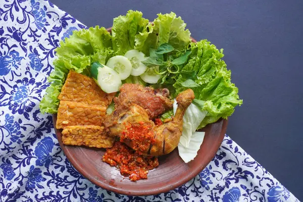 Ayam penyet, Endonezya 'da kızarmış tavuk çeşididir ve tavuk, salatalık dilimi, kızarmış tempo, marul, sambal ve biber ile servis edilir.