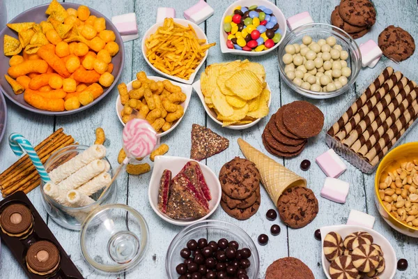 stock image Salty and sweet snacks. Table of salty and sweet snacks. Large group of unhealthy food