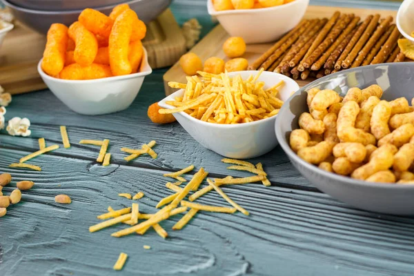 Beer salty snacks on wooden table