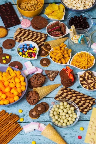 stock image Table of salty and sweet snacks. Large group of unhealthy food