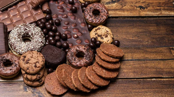 stock image Beautiful chocolate, doughnuts, chocolate stick, and chocolate chip cookies background