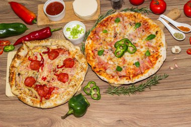 Biberli pizza ve pizza mozzarella peyniri, jambon, domates sosu, salam, mantar, biber, baharat ve taze fesleğen.