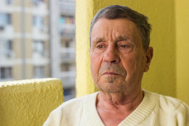 Yüzünde ciddi bir ifade olan kıdemli bir adam.