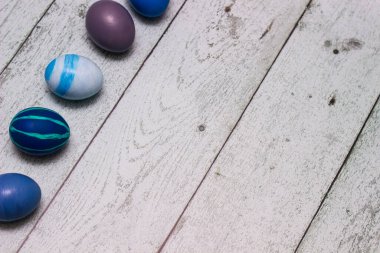 Blue Easter Eggs on old white wood background