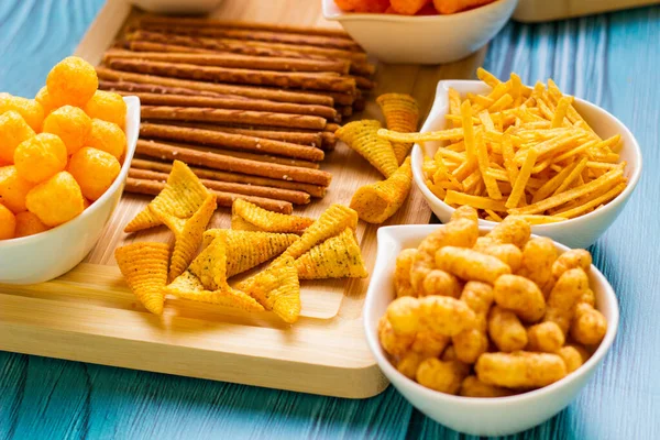Salty snacks served as party food in bowls. Party food