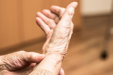Grandmother checking pulse on wrist