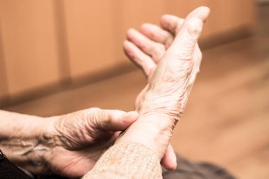 Grandmother checking pulse on wrist