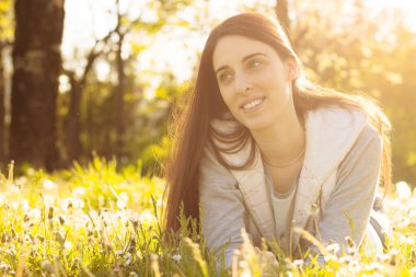 Woman enjoying the sun outdoors in sunset