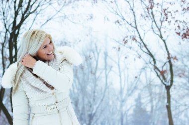 Beautiful young woman smiling, looking at camera