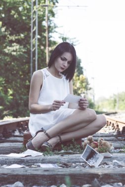 Lonely and sad girl on the railway 