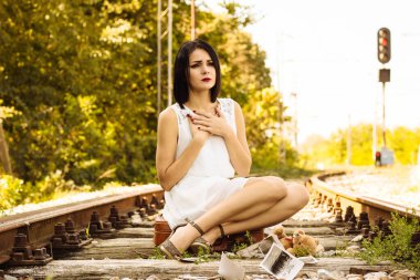 Lonely and sad girl on the railway 