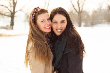 Portrait of two beautiful women, winter, snow