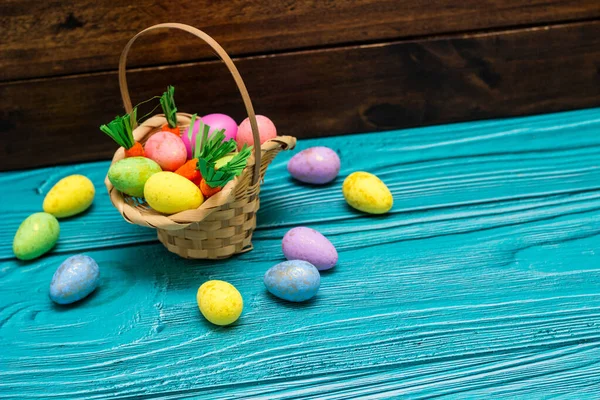 Easter eggs in basket  on empty wooden table