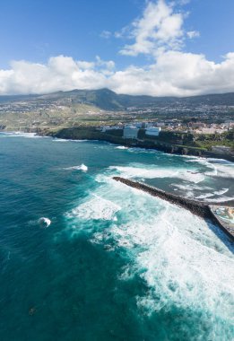 Aerial view of a black sand beach on the edge of a cliff in Puerto de la Cruz, Tenerife