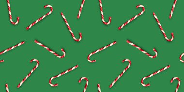 Parlak yeşil arka planda noel şekerleri ile kusursuz desen. Yaratıcı asgari Xmas sanatı. Uzayı kopyala Minimum bileşim. Düz yatıyordu.