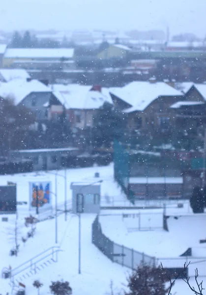 Winter city landscape. Close -down snow. Blurry background.