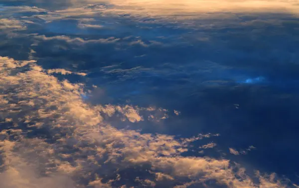 Sky landscape. Mesmerizing clouds on the background of sunset. Layered clouds. Aerial shot.