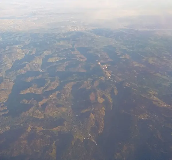 stock image The aerial view of the mountainous terrain with vegetation, sand dunes, emphasizing the natural beauty of the arid nature.