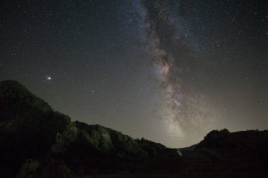 Night landscape in the Pyrenees mountains with Milky Way and planet Jupiter above, Janovas, Aragon, Huesca, Spain clipart