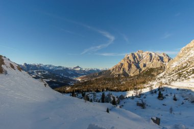 Idyllic view at dolomite mountain landscape during winter with snow covered peaks at pass road of Valparola, South Tirol, Italy clipart