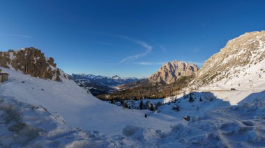 Idyllic view at dolomite mountain landscape during winter with snow covered peaks at pass road of Valparola, South Tirol, Italy clipart