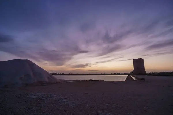 stock image Vibrant sky during evening twilight after sunset at nature reserve Saline di Trapani with salt fields and Torre Nubia, Contrada Nubia, Sicily, Italy