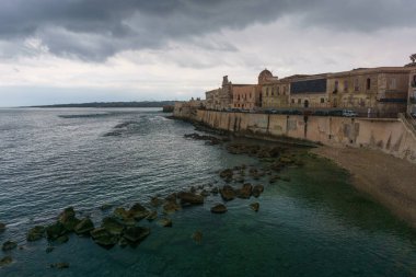 Ancient castle of Maniace at the coast on a cloudy rainy day, Syracuse, Sicily, Italy clipart