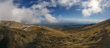 Etna Dağı 'nın kara lav ve sarı çimlerle kaplı panoramik manzarası bulutlu bir kış günü, Catania, Sicilya, İtalya