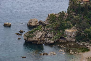 Detail view at island Isola Bella in Taormina with clear turquoise water at the mediterranean coast on a sunny day, Sicily, Italy clipart