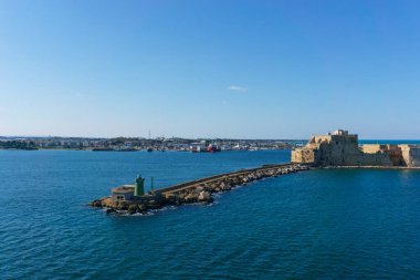 Alfonsino castle and lighthouse at the entrance to the port seen from a ferry boat while leaving, Brindisi, Puglia, Italy clipart