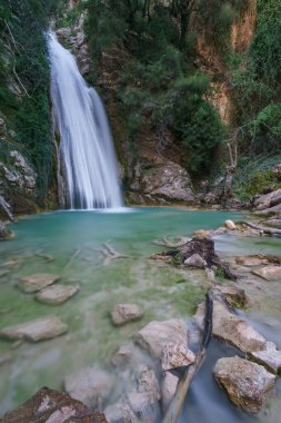 Beautiful natural waterfall of Neda with pool of torquoise water in the rural countryside, Phigalia, Peloponnese, Greece clipart