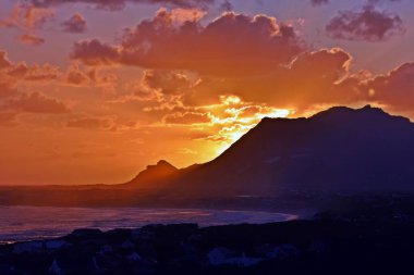 Landscape with a beautiful sunset over Betty's Bay and the False Bay clipart