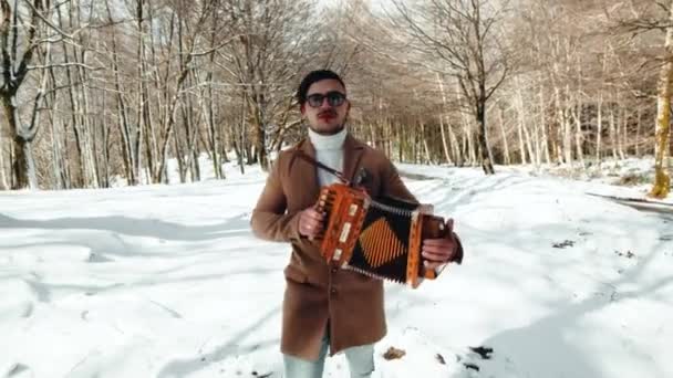 Man Plays Accordion Snowy Forest — Stock Video
