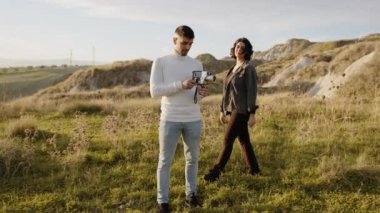 Engaged couple outdoor in a field 