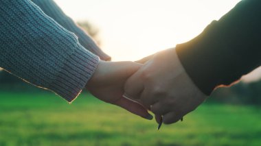 Close up of Couple hands at sunset light