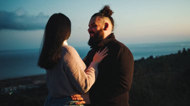 Close up of engaged couple embrace at blue hour