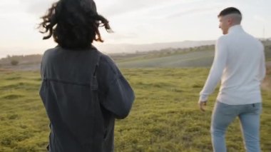 Engaged couple outdoor in a field 