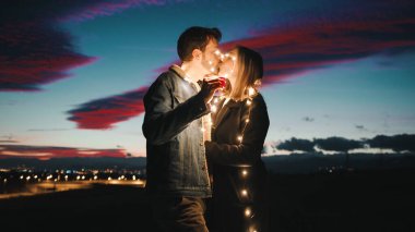 Lovely Couple At Sunset With Fairy Light.