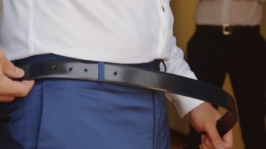 Man is wearing a belt .