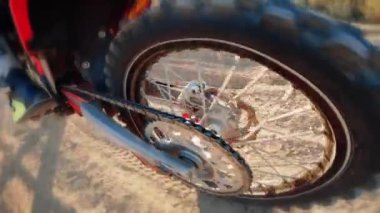 Close up of motocross wheel walks on dirt road