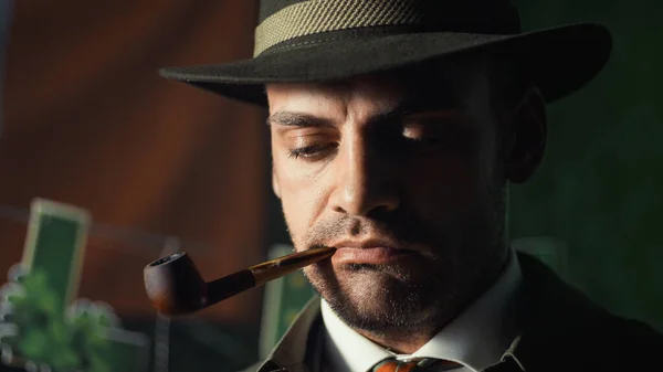 stock image Close up of detective smokes a pipe