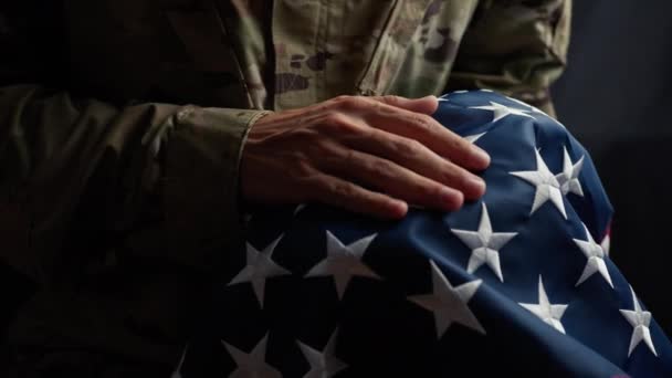 Soldier caressing the stars of a usa Flag on veterans day. 