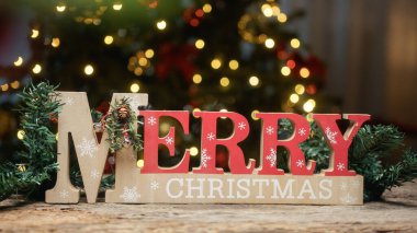 Noel ağacının altındaki Mutlu Noeller tabelası.