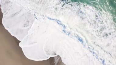 Aerial view of ocean waves crashing 