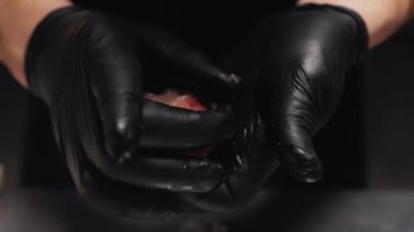 using hands to create food art . 