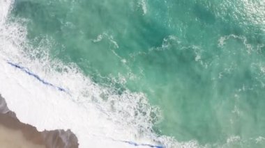 Aerial view of ocean waves crashing 