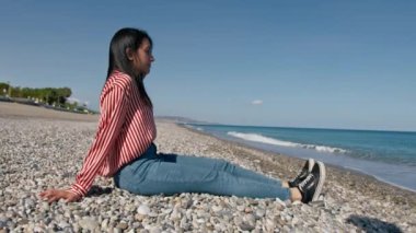 Güneşli bir günde kumsalda dinlenen bir kadın . 