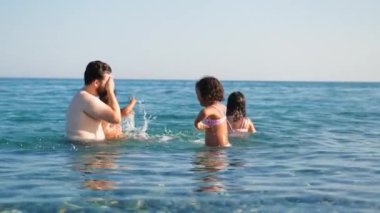 Neşeli bir aile Denizde bir günün tadını çıkarıyor.