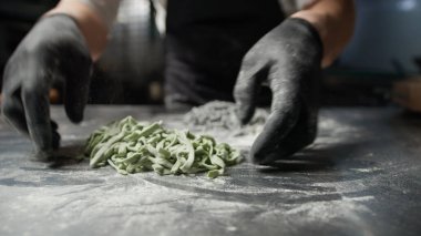 Bir Aşçının Çalışan Ellerinde Yeşil Spagetti .