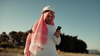 Kasklı Şeyh telefona bakıyor.. 